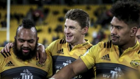 The Hurricanes first-five eighth Beauden Barrett with prop Loni Uhila and flanker Ardie Savea after the 2016 Super Rugby semi-final win