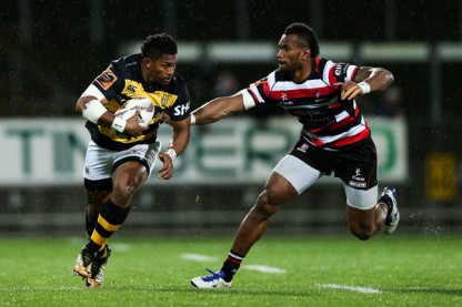Waisake Naholo is running the ball for Taranaki as Tevita Nabura from the Counties Manukau is chasing him during the Mitre 10 Cup 2017