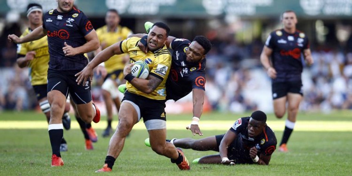The Hurricanes centre Ngani Laumape is high-tackled by the Sharks centre Lukhanyo Am during the 2019 Super Rugby fixture in South Africa
